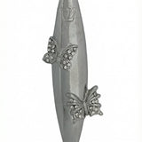 Upscale high-resolution image of a detailed butterfly-themed mezuzah made of pewter, mounted vertically on a white studio background with a soft reflection.