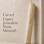 Jerusalem stone mezuzah case with large carved Hebrew letter Shin on a neutral background, highlighting its monumental size and textured architectural design.