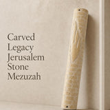 Jerusalem stone mezuzah case with large carved Hebrew letter Shin on a neutral background, highlighting its monumental size and textured architectural design.