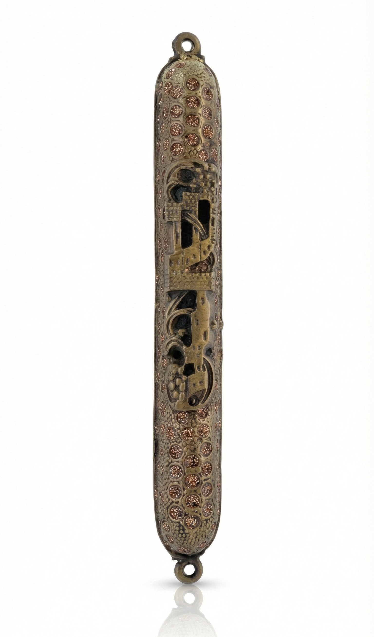 Upscale high-resolution image of a brass Cave Mezuzah with detailed engravings and Hebrew characters, displayed on a bright white studio background with soft reflection.