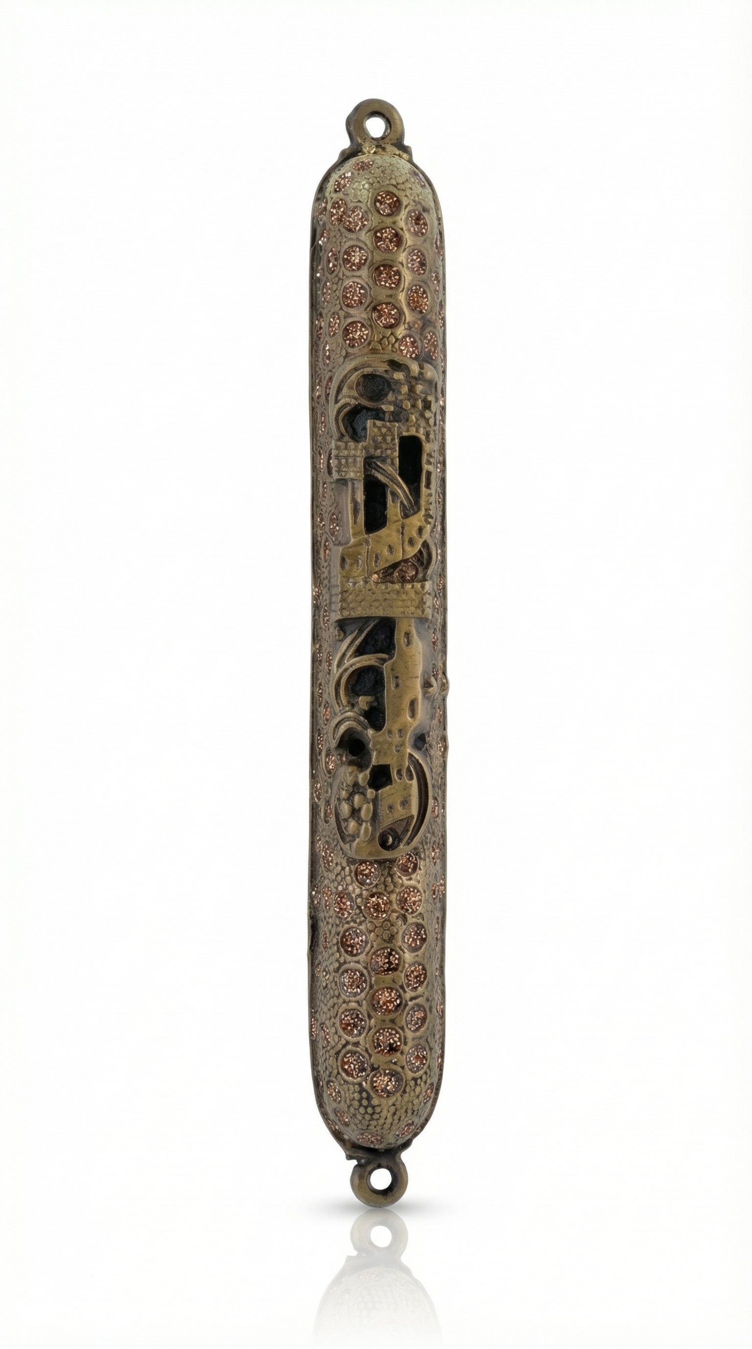 Upscale high-resolution image of a brass Cave Mezuzah with detailed engravings and Hebrew characters, displayed on a bright white studio background with soft reflection.