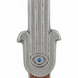 High-resolution image of a celestial Hamsa-shaped mezuzah with symbolic eye, accented with silver, turquoise, and brown sparkling paint, on a white background.