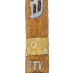 High-quality Chai to Life Mezuzah with intricate Hebrew engravings, designed for wall mounting, on a pure white background with subtle reflection.