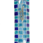 Contemporary fused-glass checkerboard Mezuzah with Hebrew symbols, mounted on a clean white background with soft reflection.