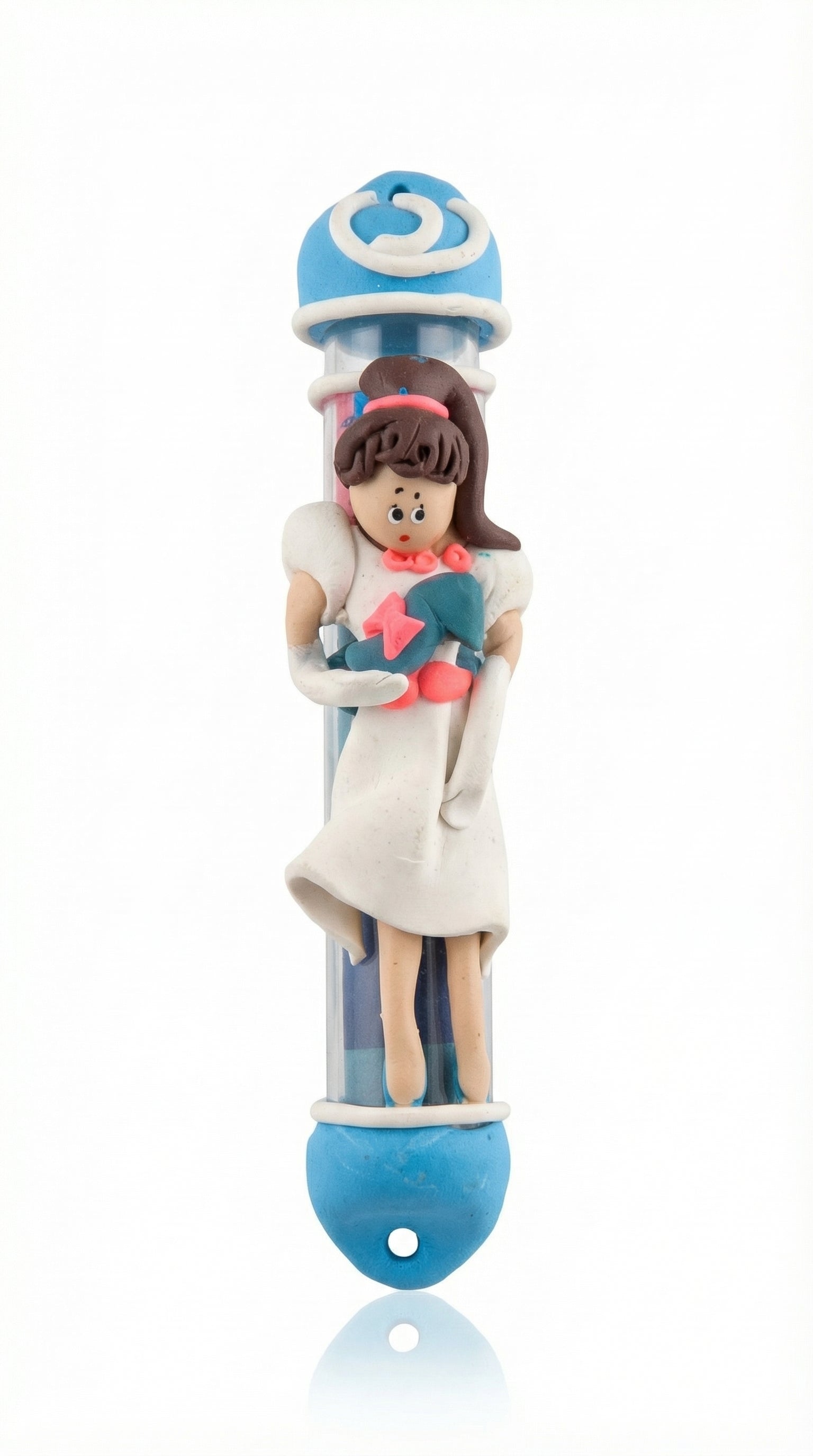 Handmade Cinderella Mezuzah crafted from fimo with protective glass tube, ideal for children's rooms, in bright studio setting with soft reflection.