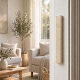 Classic Cream Gold Vein Jerusalem stone mezuzah mounted on a white doorpost in a bright neutral home, showing the slim natural stone case and raised gold Shin