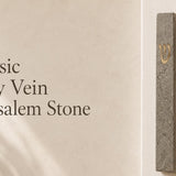 handcrafted Jerusalem stone mezuzah with gold accents, detailed texture, natural surface variations, installed on a light doorway with natural texture