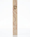 Rose Vein Jerusalem stone mezuzah case on a white background, showing a slim cream natural-stone body, rose-red mineral veining, and a raised gold Hebrew Shin