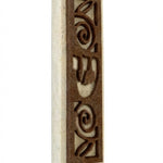 Elegant Jerusalem stone Mezuzah-Shin with natural variations, engraved Hebrew letter Shin, and decorative motifs, mounted on a white background.