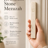 Female hand holding the classic white vein Jerusalem stone mezuzah showcasing its natural texture, subtle ivory and beige tones, and white-tone Shin