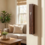 Realistic image of a beige interior doorway with a wood-inspired brown plastic mezuzah mounted on the right side, showcasing traditional Jewish decor.