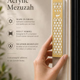 Person holding the gold acrylic mezuzah, highlighting its detailed star of david design and Hebrew Shin.