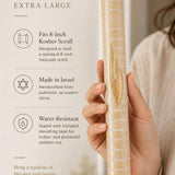 Close-up of Jerusalem stone mezuzah in hand, highlighting texture, shape, and material for online display.