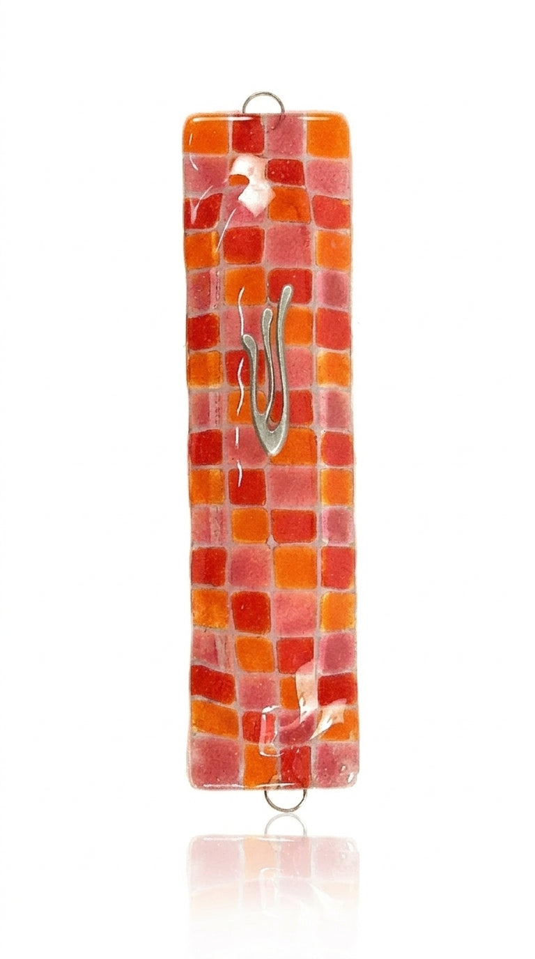 Vibrant fused-glass checkerboard Mezuzah with detailed Hebrew inscriptions, mounted on a white background with a soft reflection.