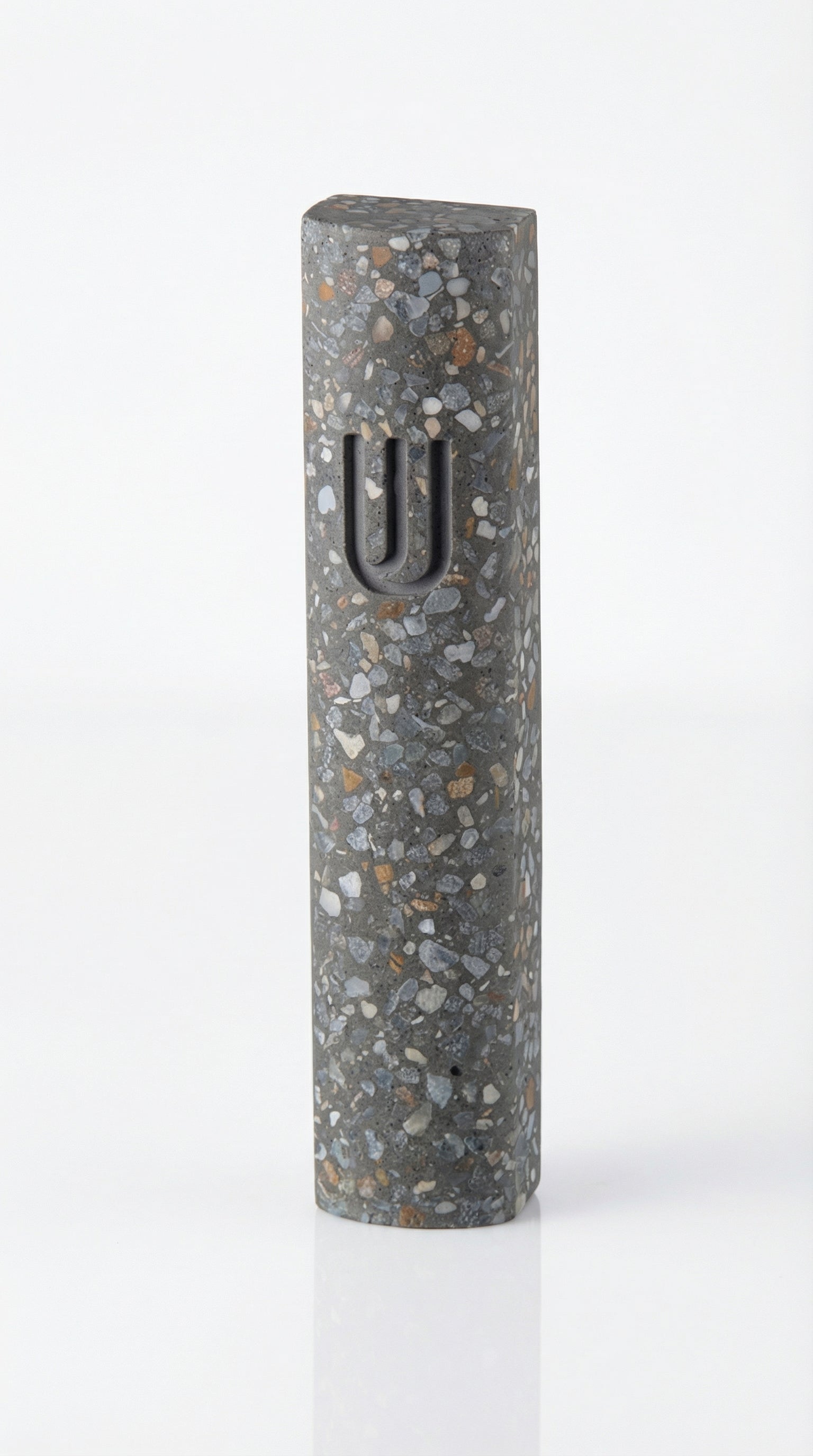Colorful cement Mezuzah case with modern design and durable finish, mounted on a clean white background with a soft reflection below.