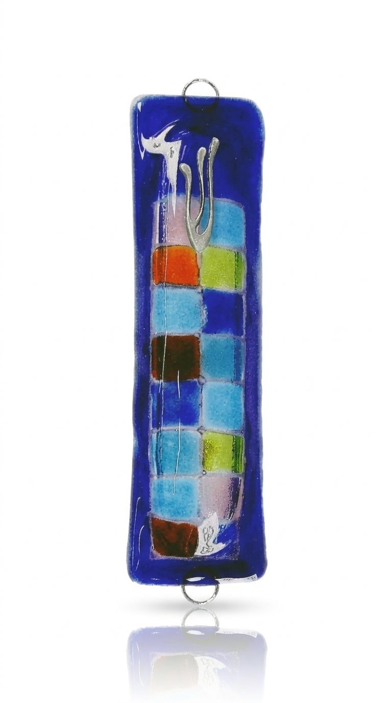 Fused-glass Mezuzah adorned with a vibrant checkered pattern, designed for home doorways, featuring detailed Hebrew inscriptions and decorative motifs.