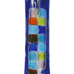 Fused-glass Mezuzah adorned with a vibrant checkered pattern, designed for home doorways, featuring detailed Hebrew inscriptions and decorative motifs.