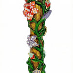 Vibrant brass mezuzah decorated with colorful flowers, intertwined vines, accent stones, layered details, and Hopeful rays on a pure white background with a subtle reflection.