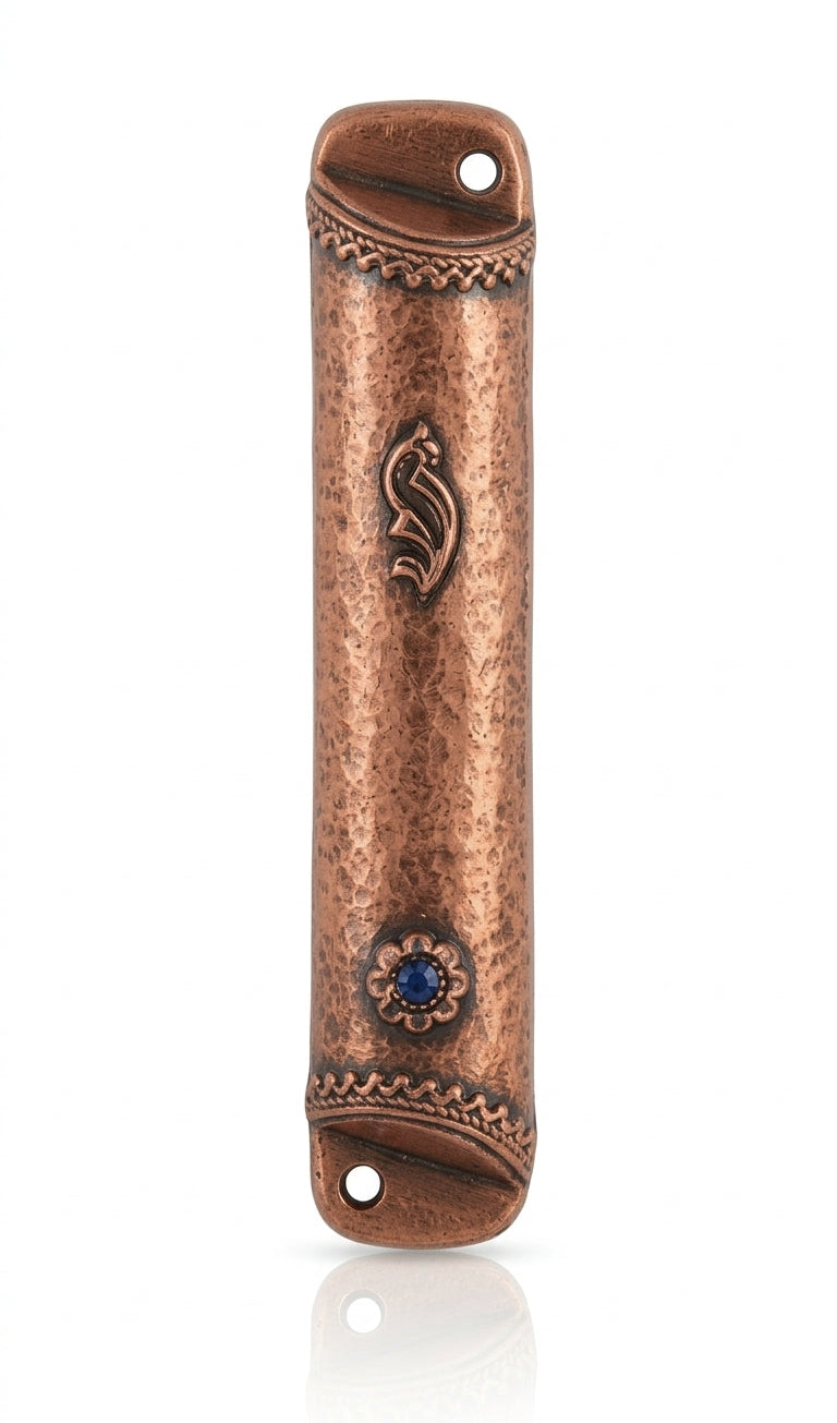Copper and blue stone mezuzah mounted on a white studio background with a soft reflection, showcasing detailed engravings and textured surface.