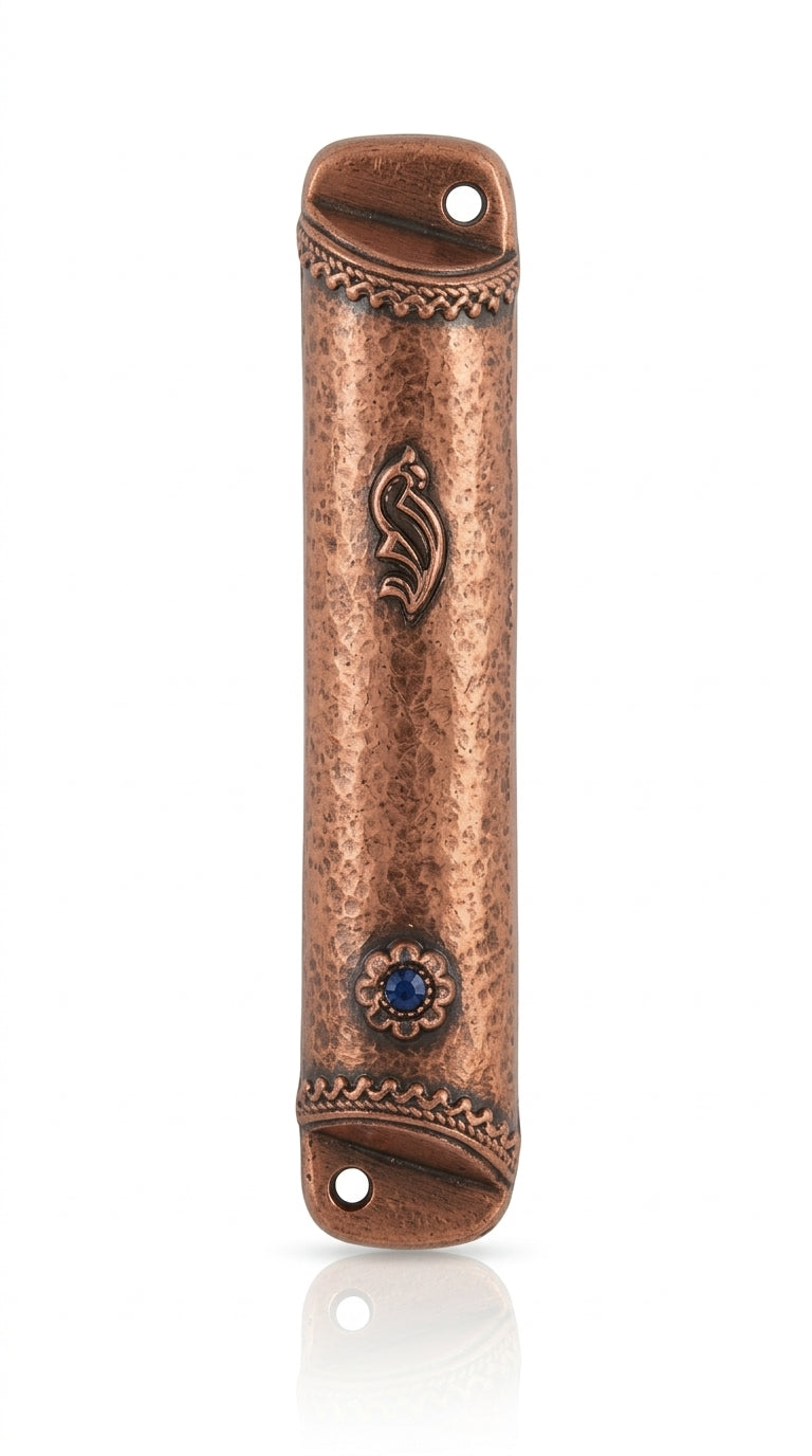Copper and blue stone mezuzah mounted on a white studio background with a soft reflection, showcasing detailed engravings and textured surface.