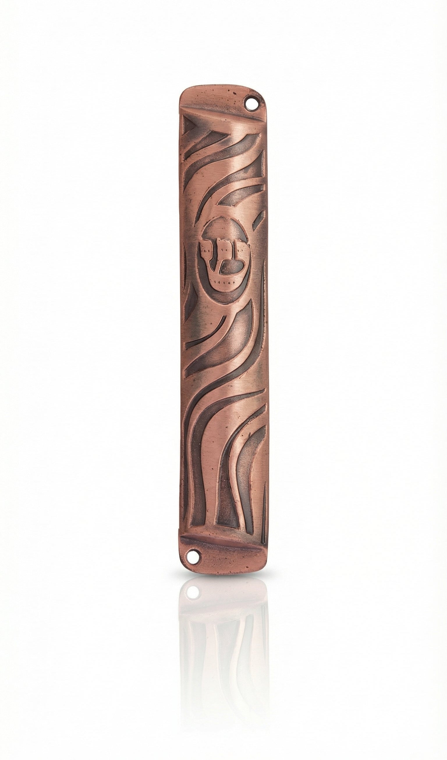 High-resolution image of a petite copper mezuzah with intricate design, Hebrew engravings, and a bright copper finish, on a white studio surface.