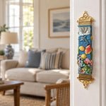 Coral reef sea life mezuzah mounted vertically on a residential doorpost in a home entryway.