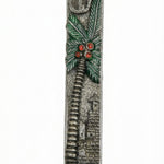 Detailed view of a handcrafted pewter mezuzah with colorful enamel accents, mounted on a white background with soft studio reflection.
