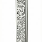 Elegant glass mezuzah with Hebrew engravings on a white background, featuring a light reflection on a polished surface.