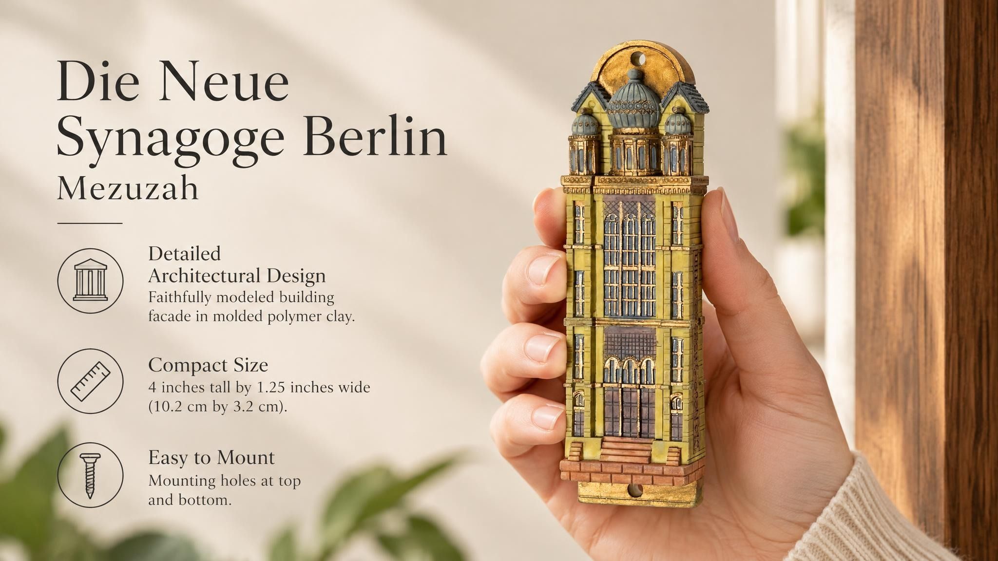 Die Neue Synagoge Berlin Mezuzah mezuzah cover held upright in one hand, showing golden ochre Fimo polymer clay shaped as the Berlin synagogue facade, with gray domes, tall windows and fine architectural relief beside the product name and illustrated design features in a wide social-sharing graphic for decorative Jewish home Judaica