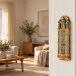 Die Neue Synagoge Berlin Mezuzah mounted vertically on a pale home doorpost, with golden ochre Fimo polymer clay shaped as the Berlin synagogue facade, with gray domes, tall windows and fine architectural relief creating a distinctive mezuzah cover that brings its Jewish design and decorative detail into the doorway