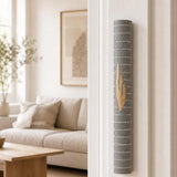Yerushalayim gray stone mezuzah mounted on a doorpost, seen on approach to the entrance.