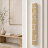 Plain cream Jerusalem stone mezuzah mounted on the right doorpost of an entryway.