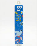 Ceramic Dove of Peace mezuzah with Hebrew letters and decorative motifs, set against a white background with soft reflection.
