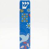 Ceramic Dove of Peace mezuzah with Hebrew letters and decorative motifs, set against a white background with soft reflection.