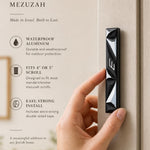 Person naturally holding the exact mezuzah in a refined editorial style with editorial text on the side, in a 9:16 premium presentation.