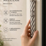 A person holds an elegant crowned spiral stainless steel mezuzah case featuring intricate beaded details and a central Shin.