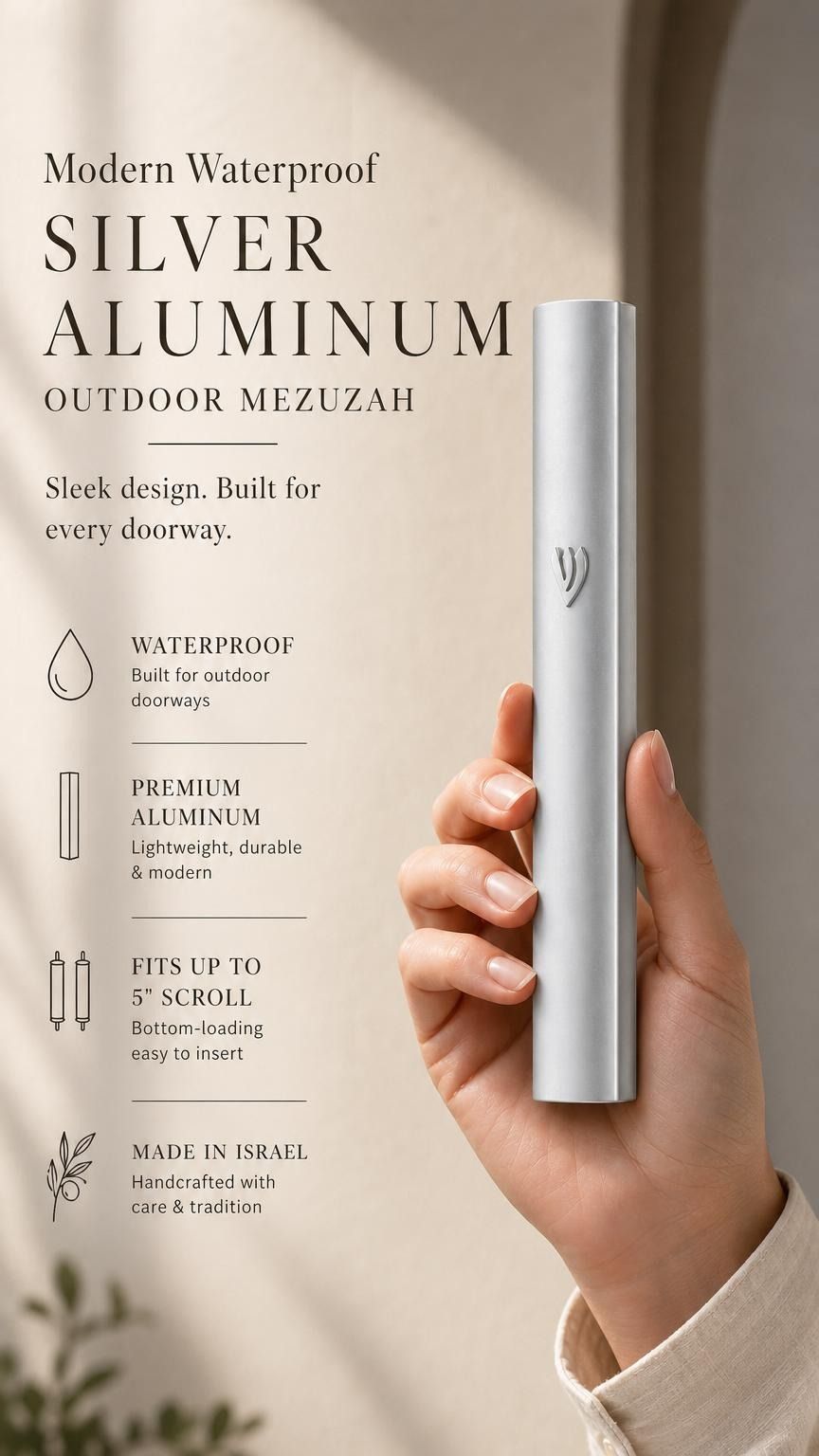 Handheld view of the sleek silver aluminum mezuzah, balanced with editorial text, showcasing its modern design and refined finish.