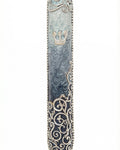 Elegant pewter mezuzah hand painted with enamel, measuring 5 inches tall, with intricate swirl details and Hebrew inscription, on a white studio background with soft reflection.