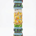Detailed wooden mezuzah with Hebrew inscriptions and decorative motifs on a white background with soft reflection.