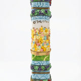 Detailed wooden mezuzah with Hebrew inscriptions and decorative motifs on a white background with soft reflection.