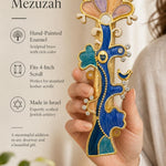 Person holding the brass made unique enamel Tree of Life mezuzah showing craftsmanship and vibrant crystal details