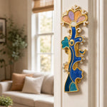 the Enamel Tree of Life Mezuzah cover mounted vertically on a an indoor doorpost near the entryway of a home