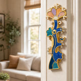the Enamel Tree of Life Mezuzah cover mounted vertically on a an indoor doorpost near the entryway of a home