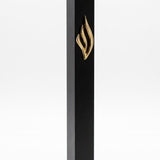 Slim black aluminum mezuzah made in Israel with a raised polished gold eternal-flame emblem on the front