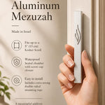 Eternal Flame silver aluminum mezuzah case held against a light-colored doorpost, showing its slim profile and raised ner tamid emblem; made in Israel, waterproof, and sized for up to a 5-inch kosher scroll
