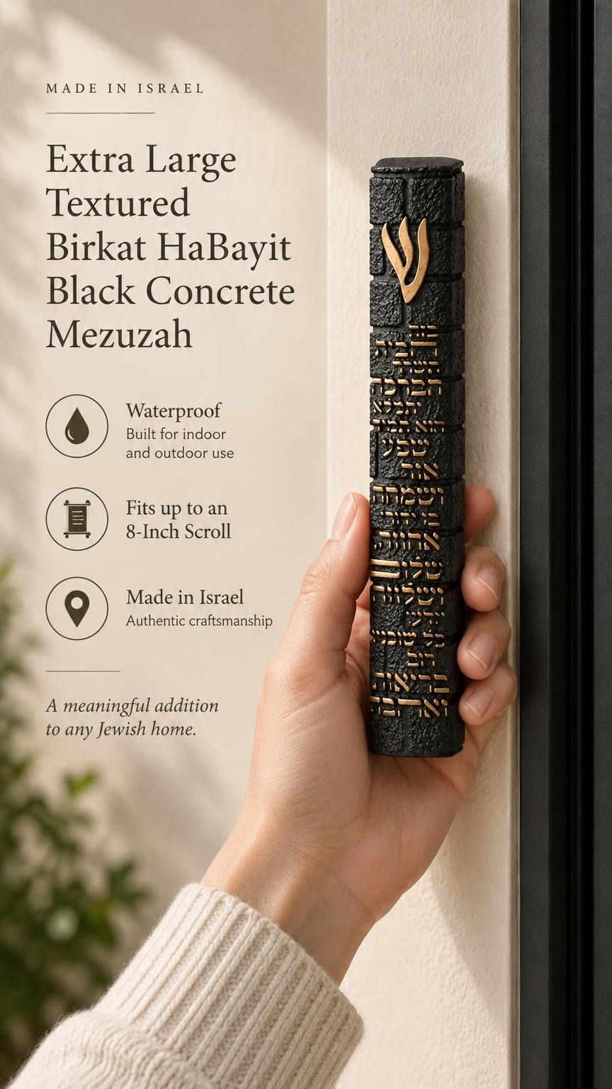 Hand holding an extra large textured black concrete mezuzah with gold Birkat HaBayit lettering and a raised gold Shin against the doorway of a home