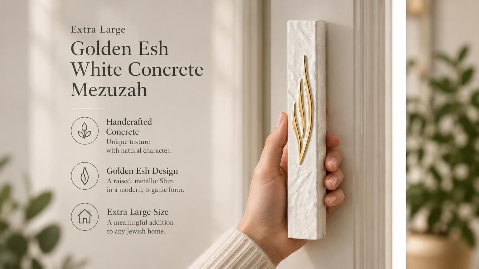 Person holding an extra large white concrete mezuzah with a gold flame-like Shin letter design.