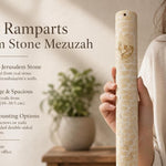Hand-held Jerusalem stone mezuzah in warm gold with carved wall pattern and Hebrew Shin, showing detailed texture and design.