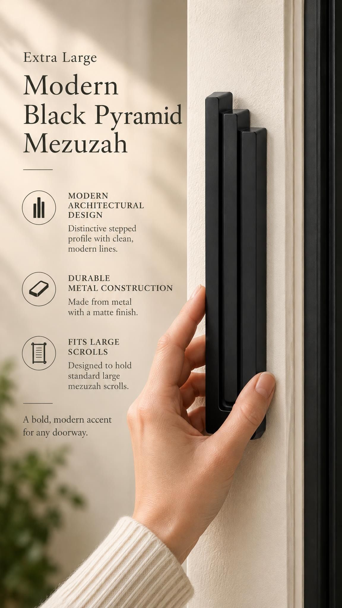 Extra Large Modern Black Pyramid Mezuzah held beside a doorpost, with the deep matte black aluminum mezuzah cover shown close enough to reveal its three stepped bars and rounded lower edge alongside product-name and design callouts for this minimalist Judaica piece