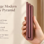 Extra Large Modern Burgundy Pyramid Mezuzah pictured in hand as a muted burgundy wine-red aluminum mezuzah cover with three graduated bars and a minimalist stepped design, alongside its name and illustrated product features in a wide social-sharing image
